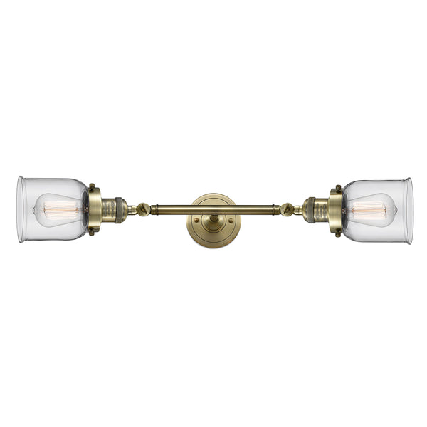 Bell Bath Vanity Light shown in the Antique Brass finish with a Clear shade