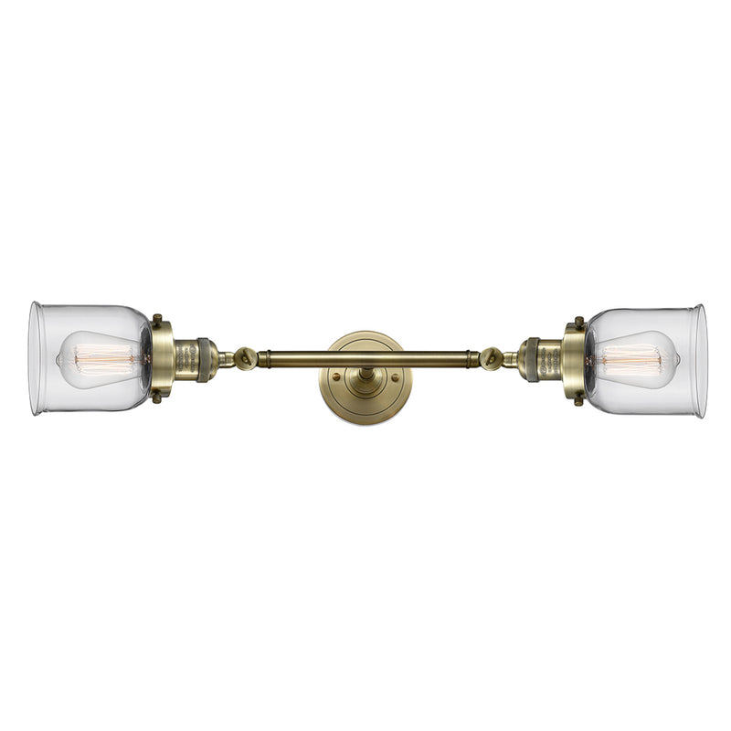 Bell Bath Vanity Light shown in the Antique Brass finish with a Clear shade