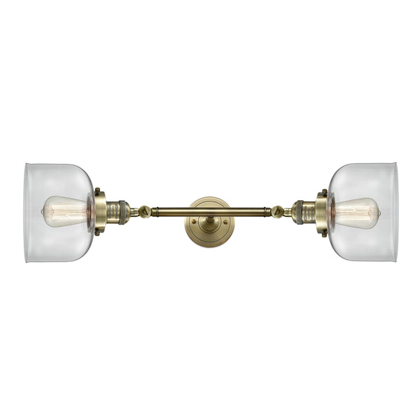 Bell Bath Vanity Light shown in the Antique Brass finish with a Clear shade