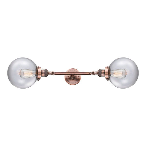 Beacon Bath Vanity Light shown in the Antique Copper finish with a Clear shade