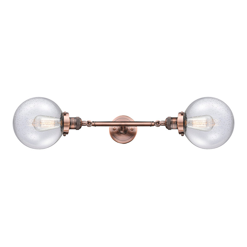 Beacon Bath Vanity Light shown in the Antique Copper finish with a Seedy shade