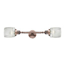 Colton Bath Vanity Light shown in the Antique Copper finish with a Clear Halophane shade