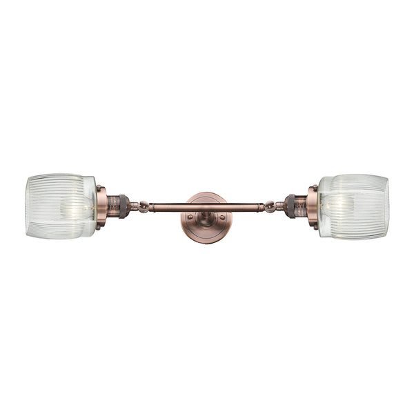 Colton Bath Vanity Light shown in the Antique Copper finish with a Clear Halophane shade