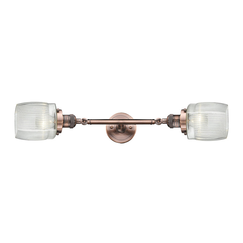 Colton Bath Vanity Light shown in the Antique Copper finish with a Clear Halophane shade