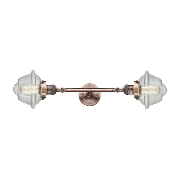 Oxford Bath Vanity Light shown in the Antique Copper finish with a Seedy shade