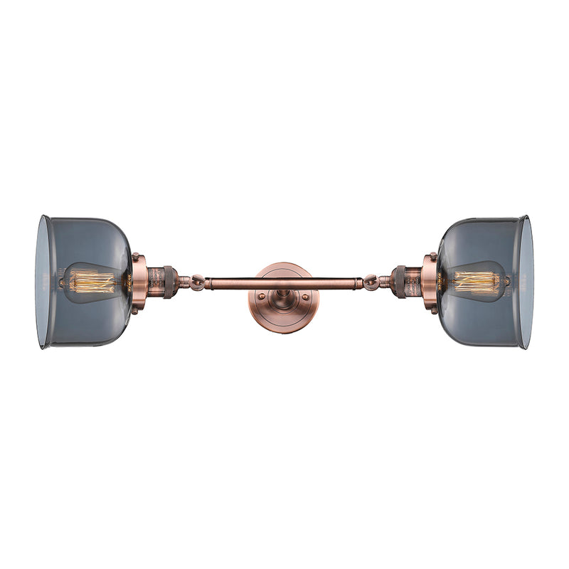 Bell Bath Vanity Light shown in the Antique Copper finish with a Plated Smoke shade