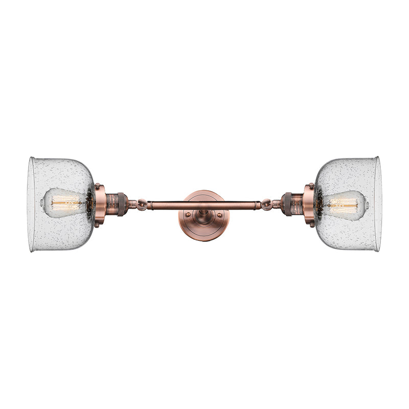 Bell Bath Vanity Light shown in the Antique Copper finish with a Seedy shade