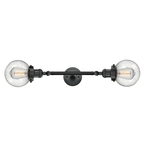 Beacon Bath Vanity Light shown in the Matte Black finish with a Seedy shade
