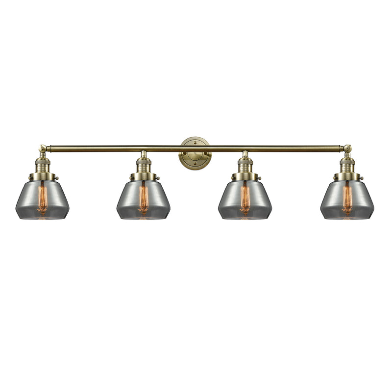 Fulton Bath Vanity Light shown in the Antique Brass finish with a Plated Smoke shade