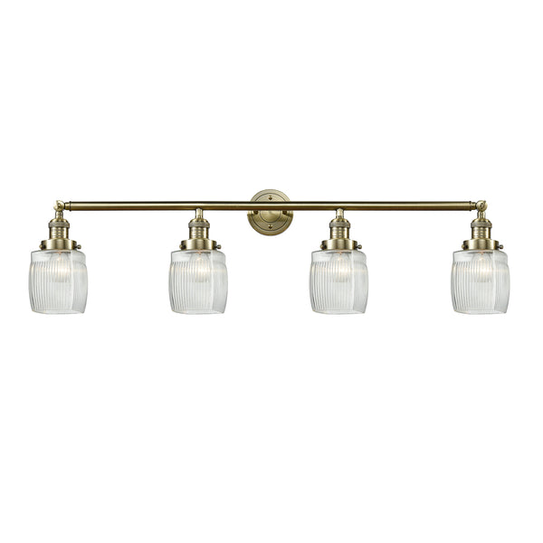 Colton Bath Vanity Light shown in the Antique Brass finish with a Clear Halophane shade
