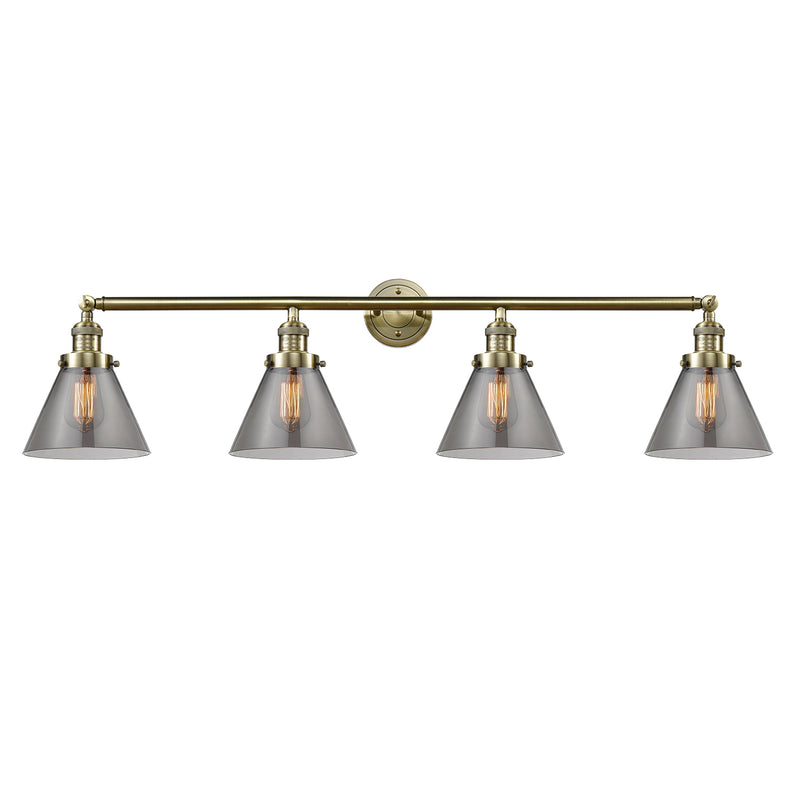 Cone Bath Vanity Light shown in the Antique Brass finish with a Plated Smoke shade