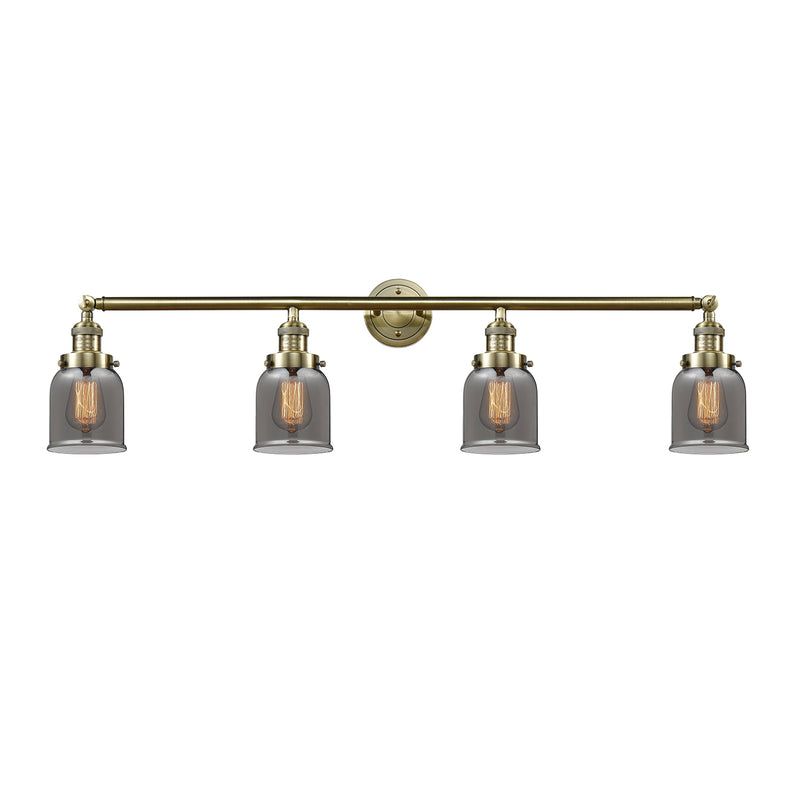 Bell Bath Vanity Light shown in the Antique Brass finish with a Plated Smoke shade