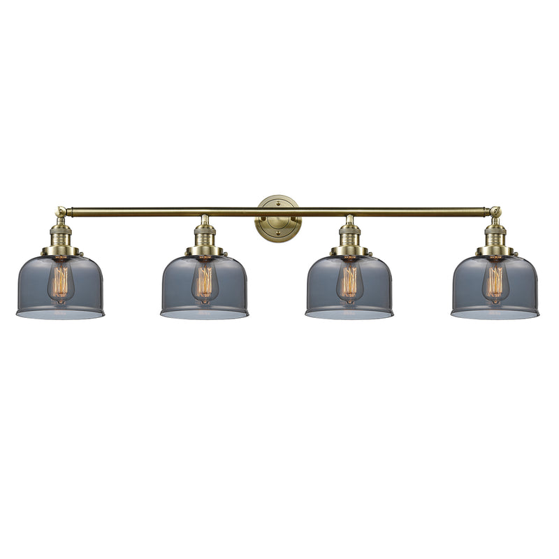 Bell Bath Vanity Light shown in the Antique Brass finish with a Plated Smoke shade