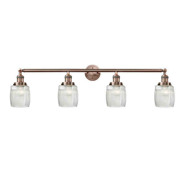 Colton Bath Vanity Light shown in the Antique Copper finish with a Clear Halophane shade