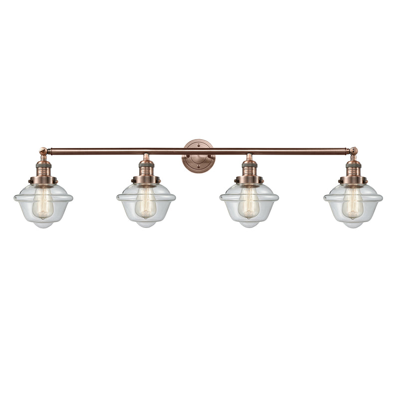 Oxford Bath Vanity Light shown in the Antique Copper finish with a Clear shade