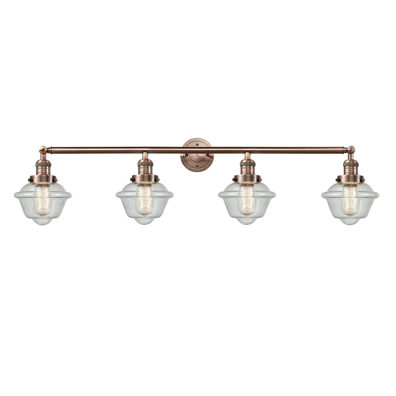 Oxford Bath Vanity Light shown in the Antique Copper finish with a Seedy shade