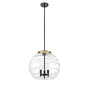 Deco Swirl Pendant shown in the Black Antique Brass finish with a Clear shade