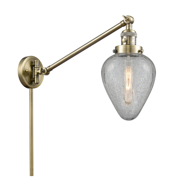 Geneseo Swing Arm shown in the Antique Brass finish with a Clear Crackled shade