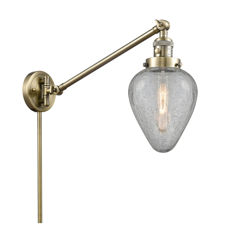 Geneseo Swing Arm shown in the Antique Brass finish with a Clear Crackled shade