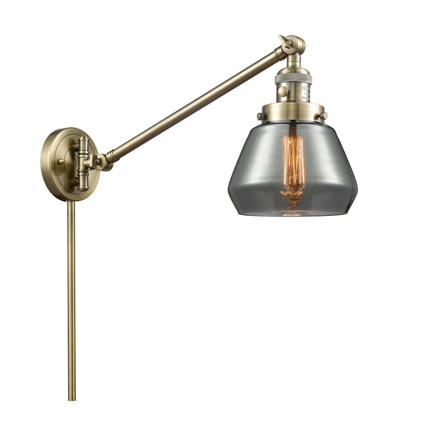 Fulton Swing Arm shown in the Antique Brass finish with a Plated Smoke shade