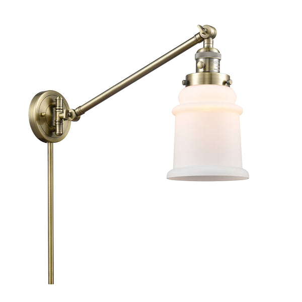 Canton Swing Arm shown in the Antique Brass finish with a Matte White shade
