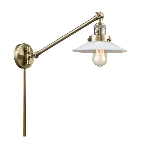 Halophane Swing Arm shown in the Antique Brass finish with a Matte White Halophane shade