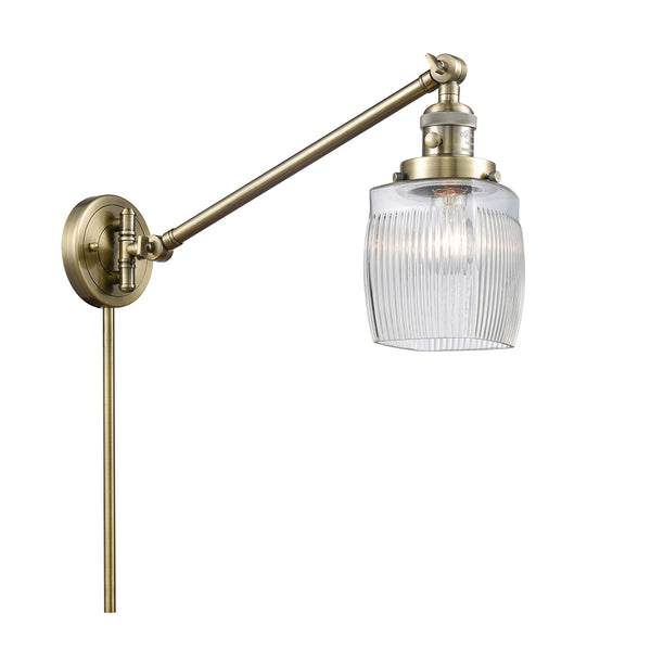 Colton Swing Arm shown in the Antique Brass finish with a Clear Halophane shade