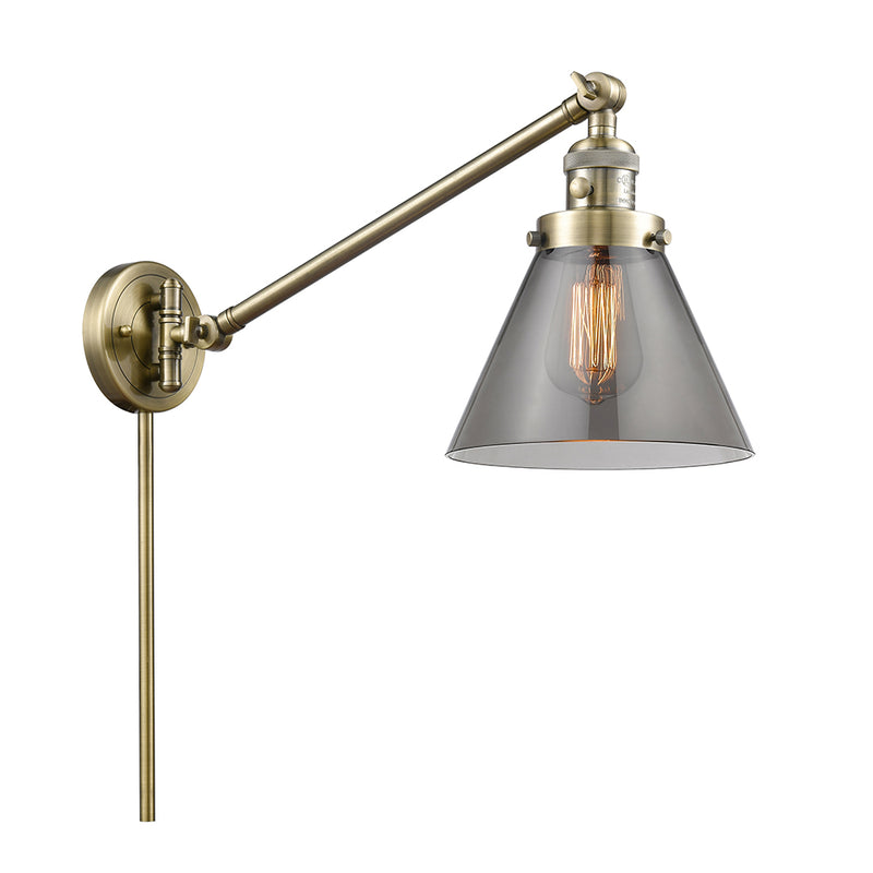 Cone Swing Arm shown in the Antique Brass finish with a Plated Smoke shade