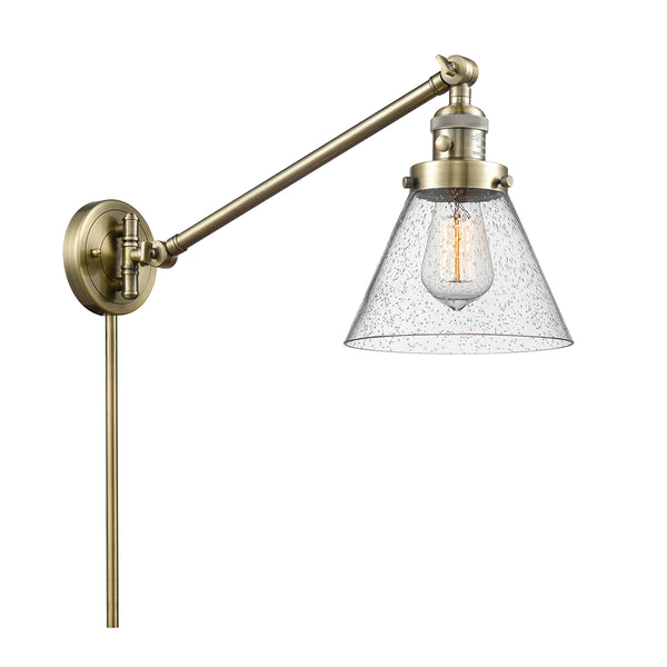 Cone Swing Arm shown in the Antique Brass finish with a Seedy shade