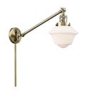Oxford Swing Arm shown in the Antique Brass finish with a Matte White shade