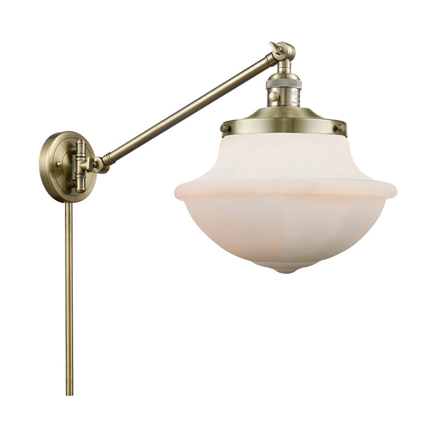 Oxford Swing Arm shown in the Antique Brass finish with a Matte White shade