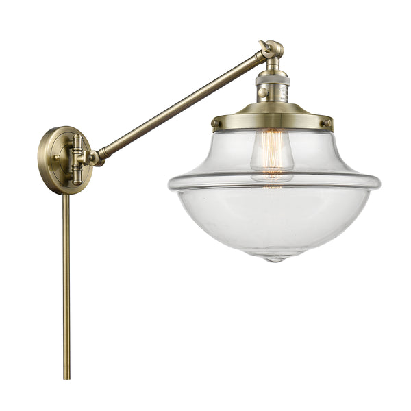 Oxford Swing Arm shown in the Antique Brass finish with a Clear shade