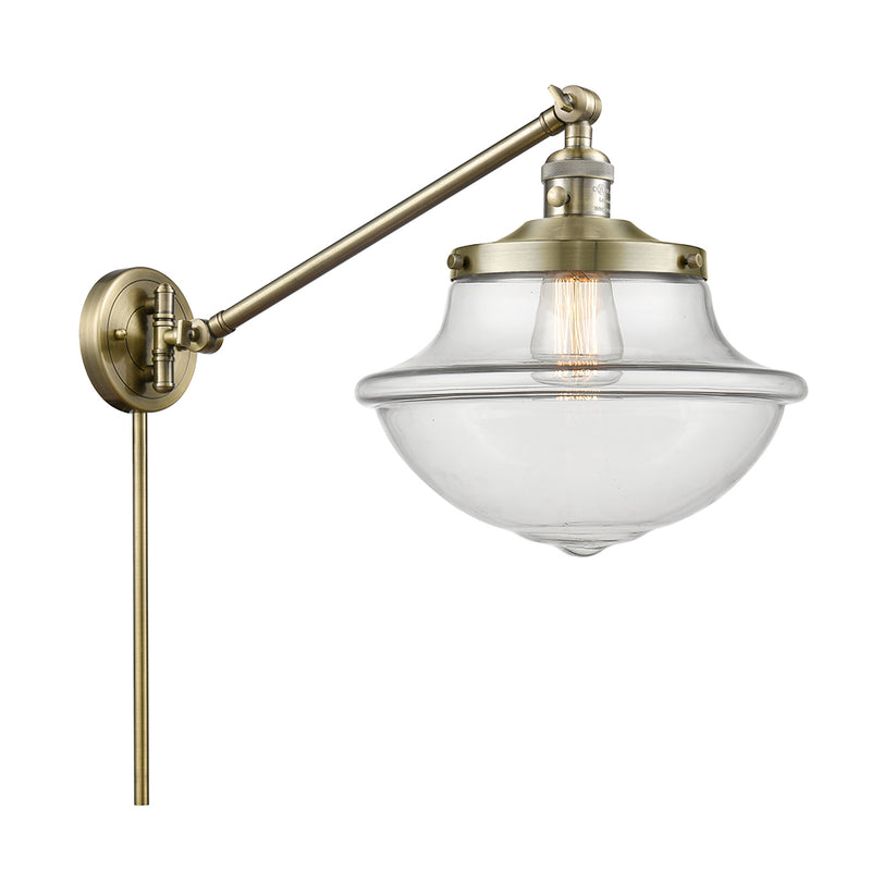 Oxford Swing Arm shown in the Antique Brass finish with a Clear shade