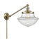 Oxford Swing Arm shown in the Antique Brass finish with a Clear shade