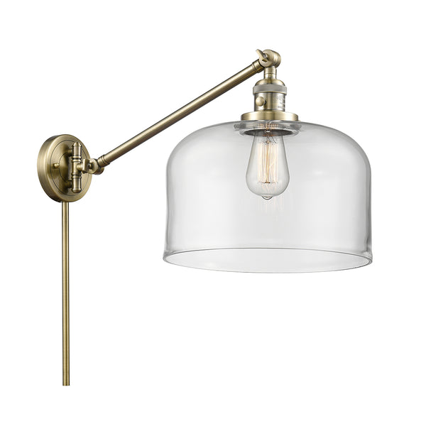 Bell Swing Arm shown in the Antique Brass finish with a Clear shade