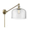 Bell Swing Arm shown in the Antique Brass finish with a Clear shade