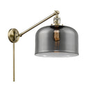 Bell Swing Arm shown in the Antique Brass finish with a Plated Smoke shade