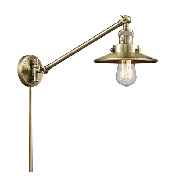 Railroad Swing Arm shown in the Antique Brass finish with a Antique Brass shade