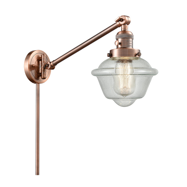Oxford Swing Arm shown in the Antique Copper finish with a Seedy shade