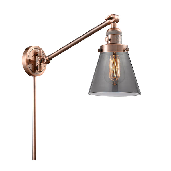 Cone Swing Arm shown in the Antique Copper finish with a Plated Smoke shade