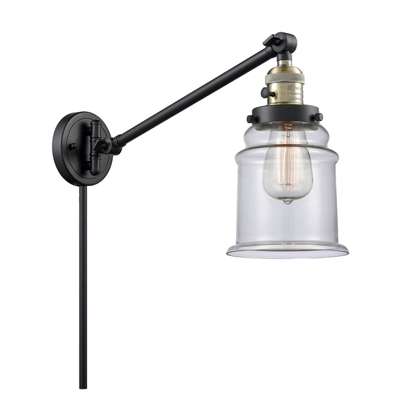 Canton Swing Arm shown in the Black Antique Brass finish with a Clear shade