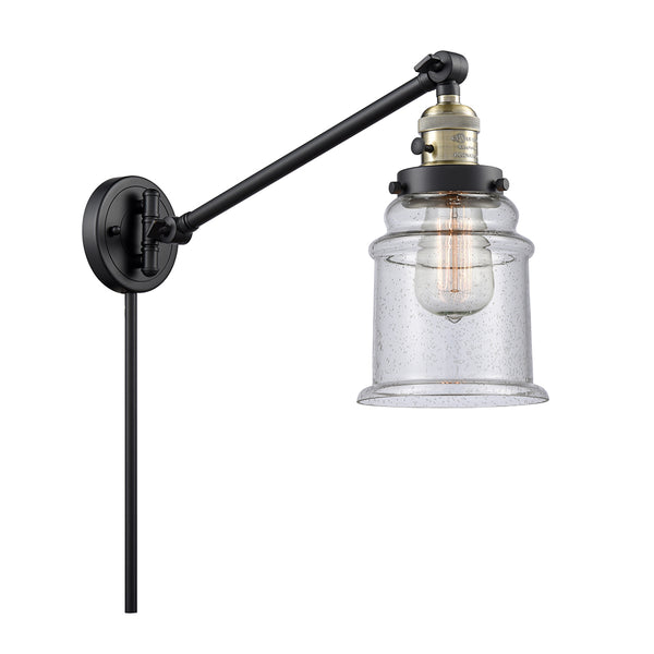 Canton Swing Arm shown in the Black Antique Brass finish with a Seedy shade