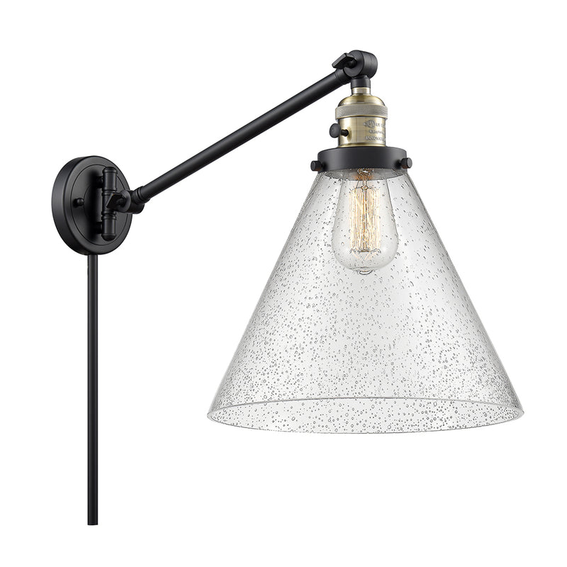 Cone Swing Arm shown in the Black Antique Brass finish with a Seedy shade