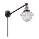 Oxford Swing Arm shown in the Black Antique Brass finish with a Seedy shade