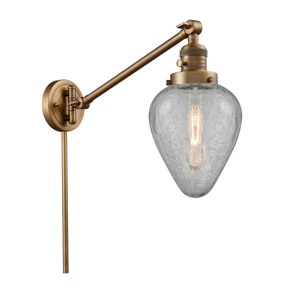 Geneseo Swing Arm shown in the Brushed Brass finish with a Clear Crackled shade