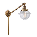 Oxford Swing Arm shown in the Brushed Brass finish with a Clear shade