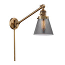 Cone Swing Arm shown in the Brushed Brass finish with a Plated Smoke shade
