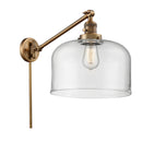 Bell Swing Arm shown in the Brushed Brass finish with a Clear shade