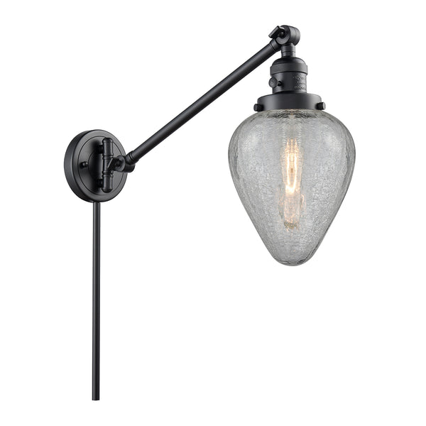 Geneseo Swing Arm shown in the Matte Black finish with a Clear Crackled shade