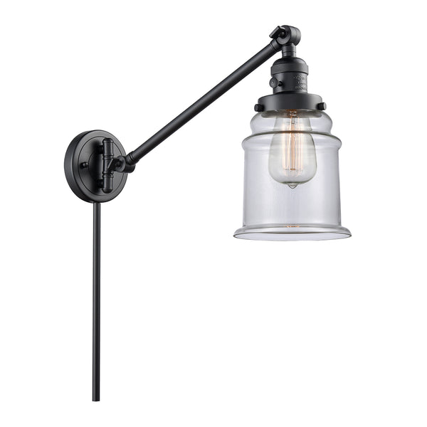 Canton Swing Arm shown in the Matte Black finish with a Clear shade